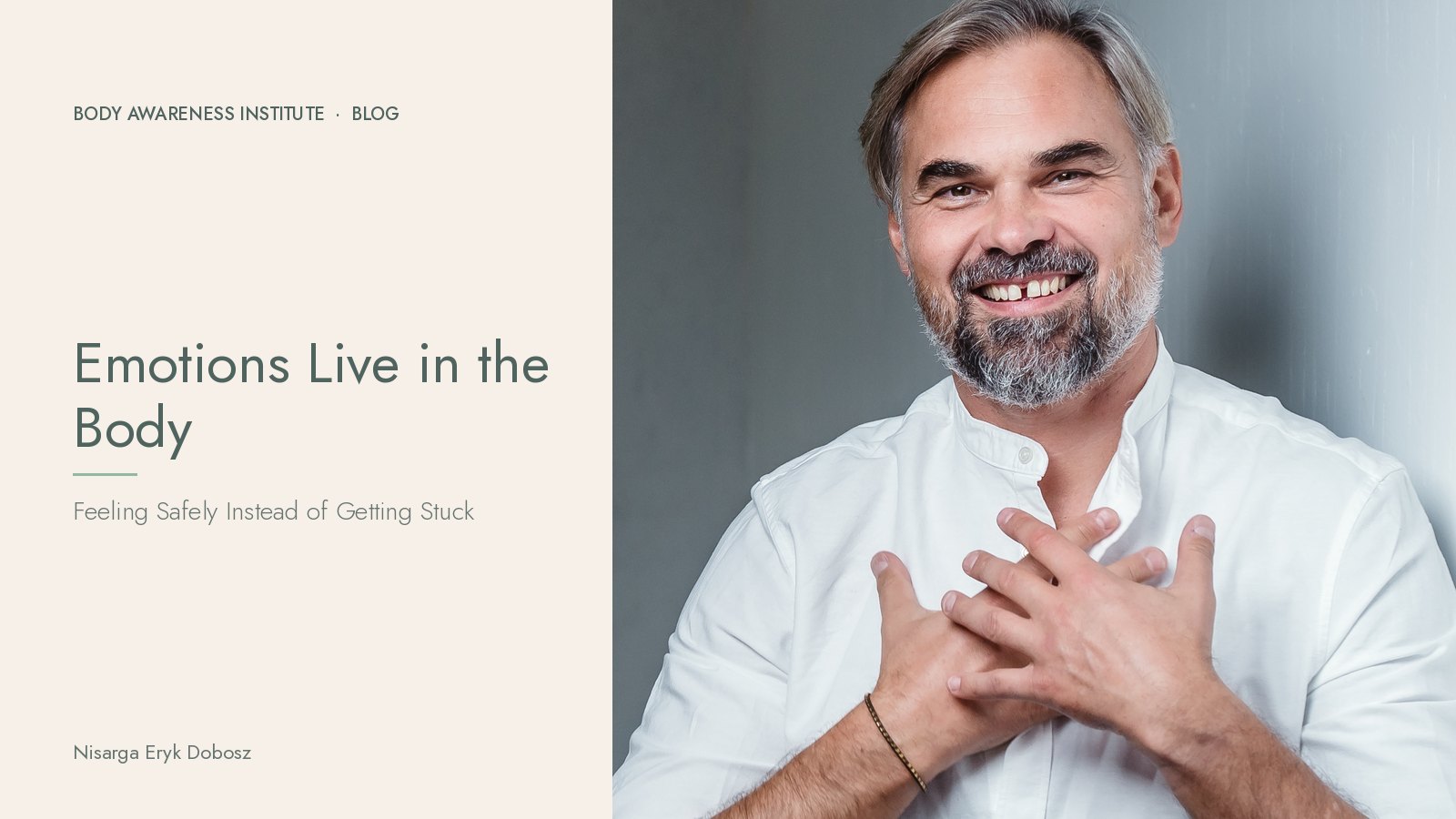 Nisarga Eryk Dobosz smiling with both hands on his heart